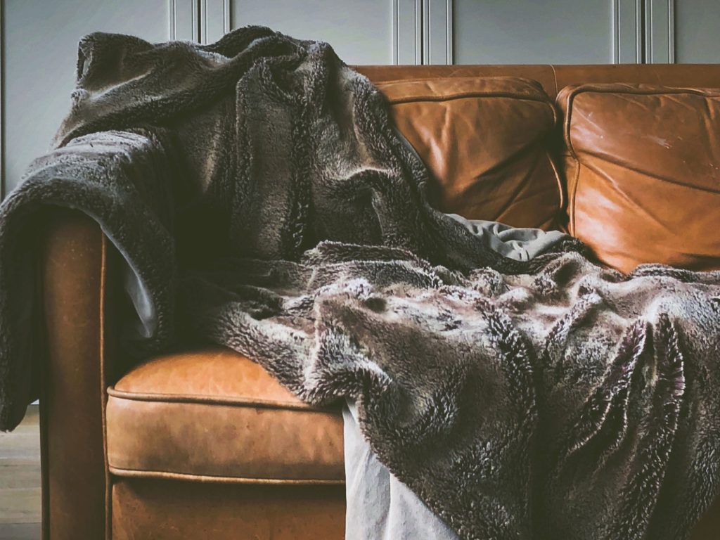 Leather sofa with a soft throw in a living room